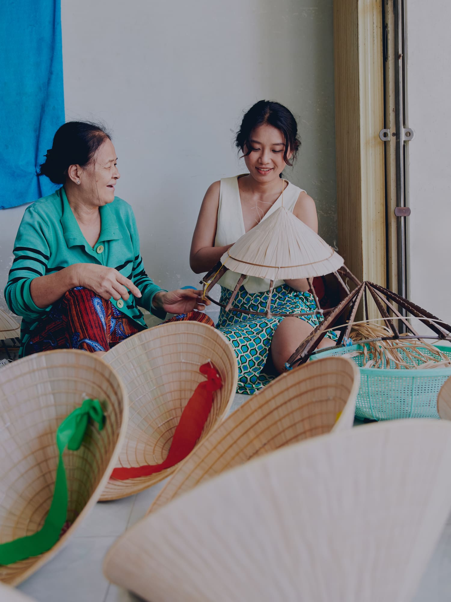a woman and a woman sitting next to hats
