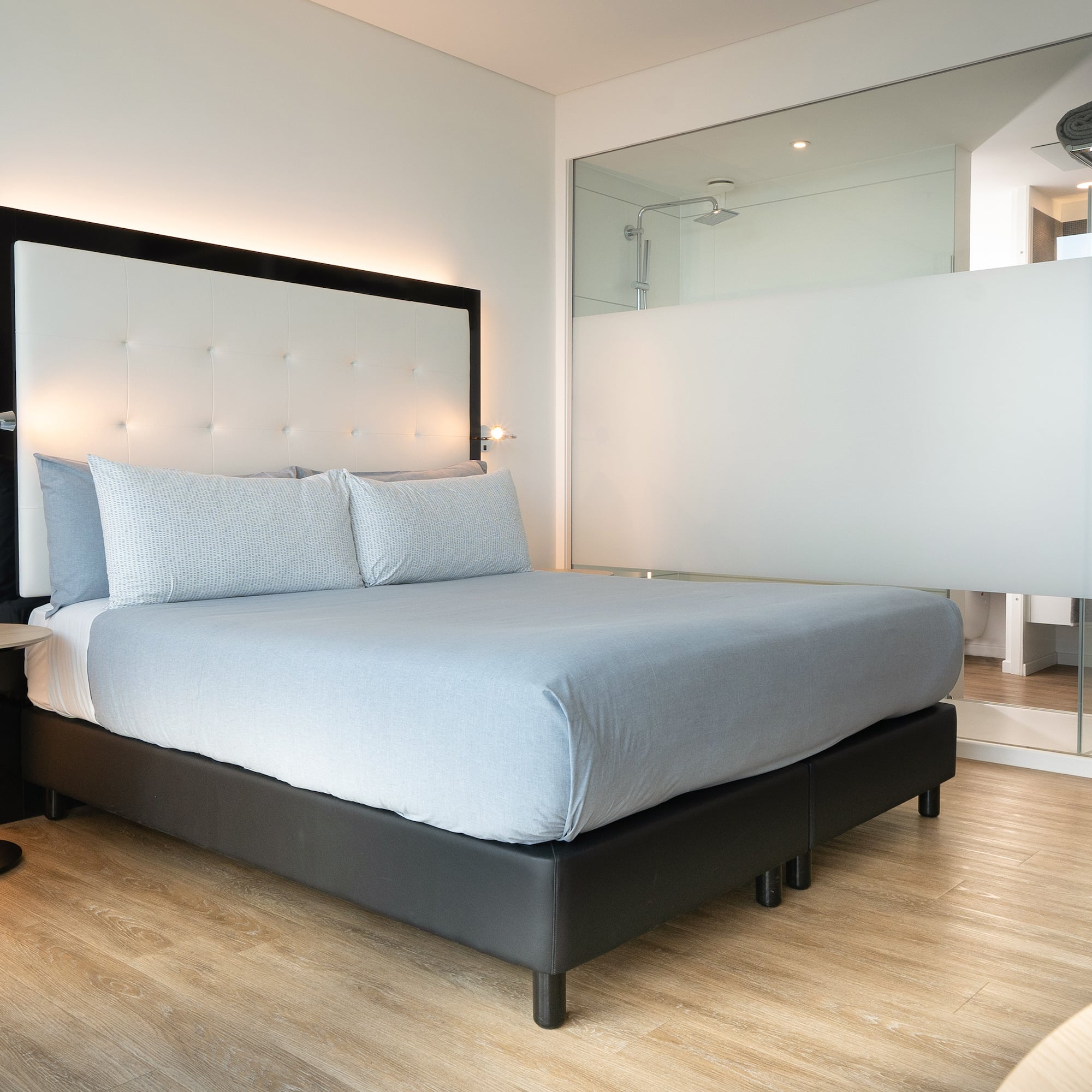 a bed with a large mirror