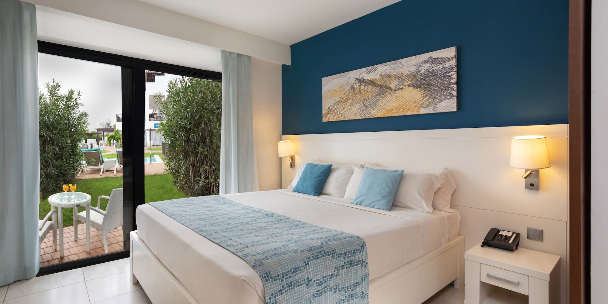 a bedroom with a bed and a glass door