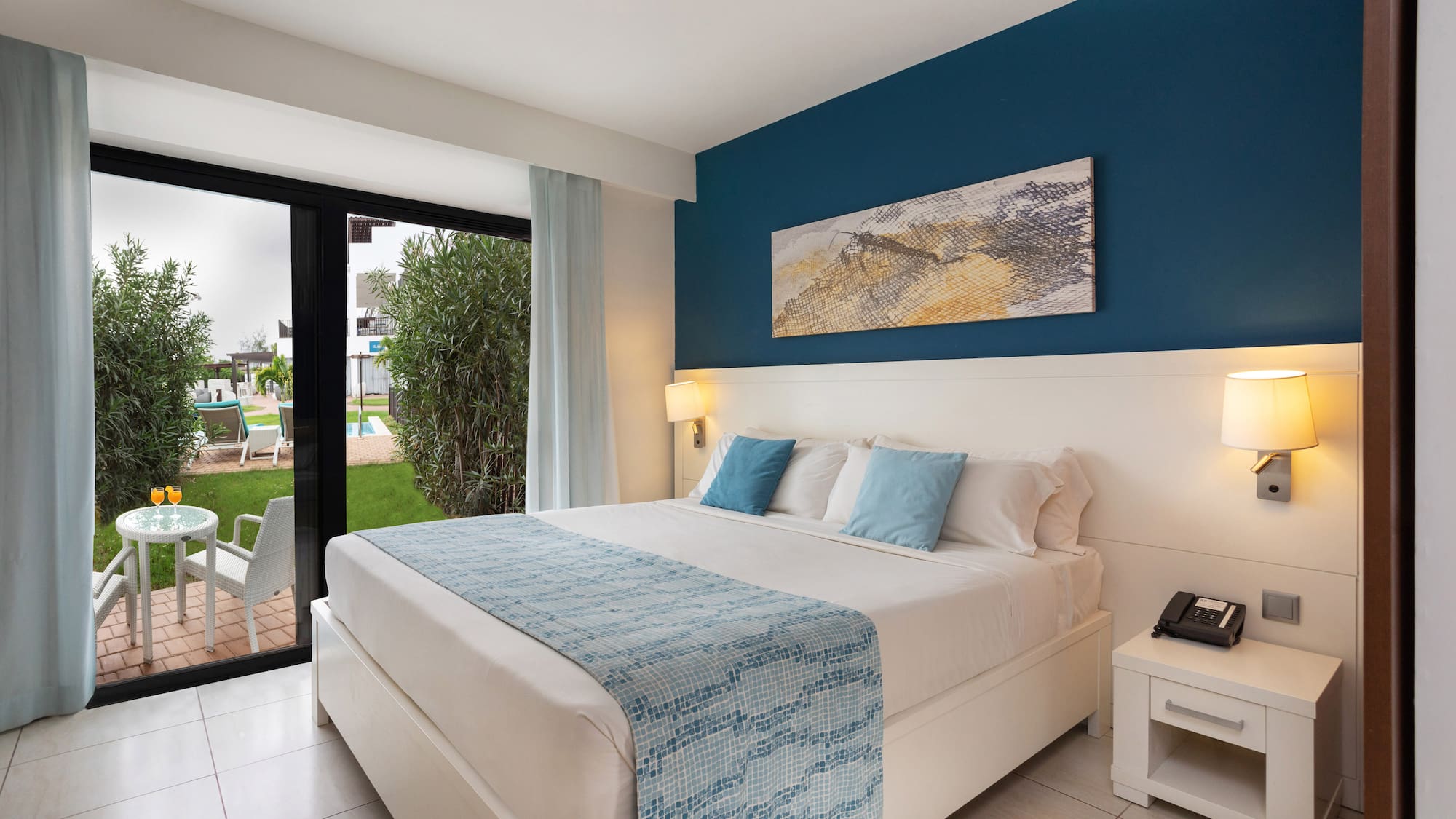 a bedroom with a bed and a glass door