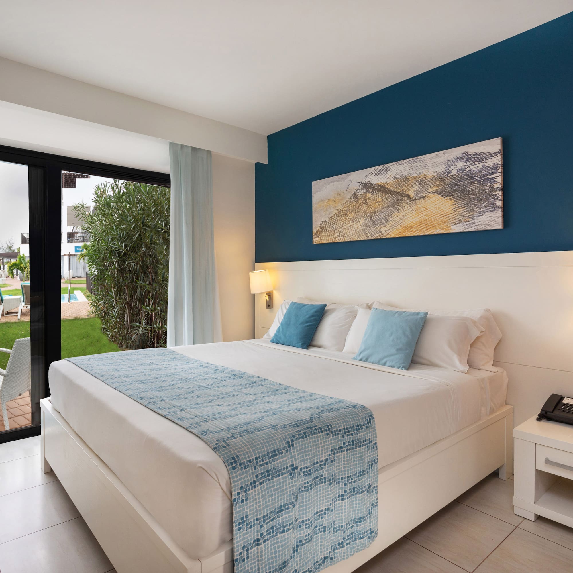 a bedroom with a bed and a glass door