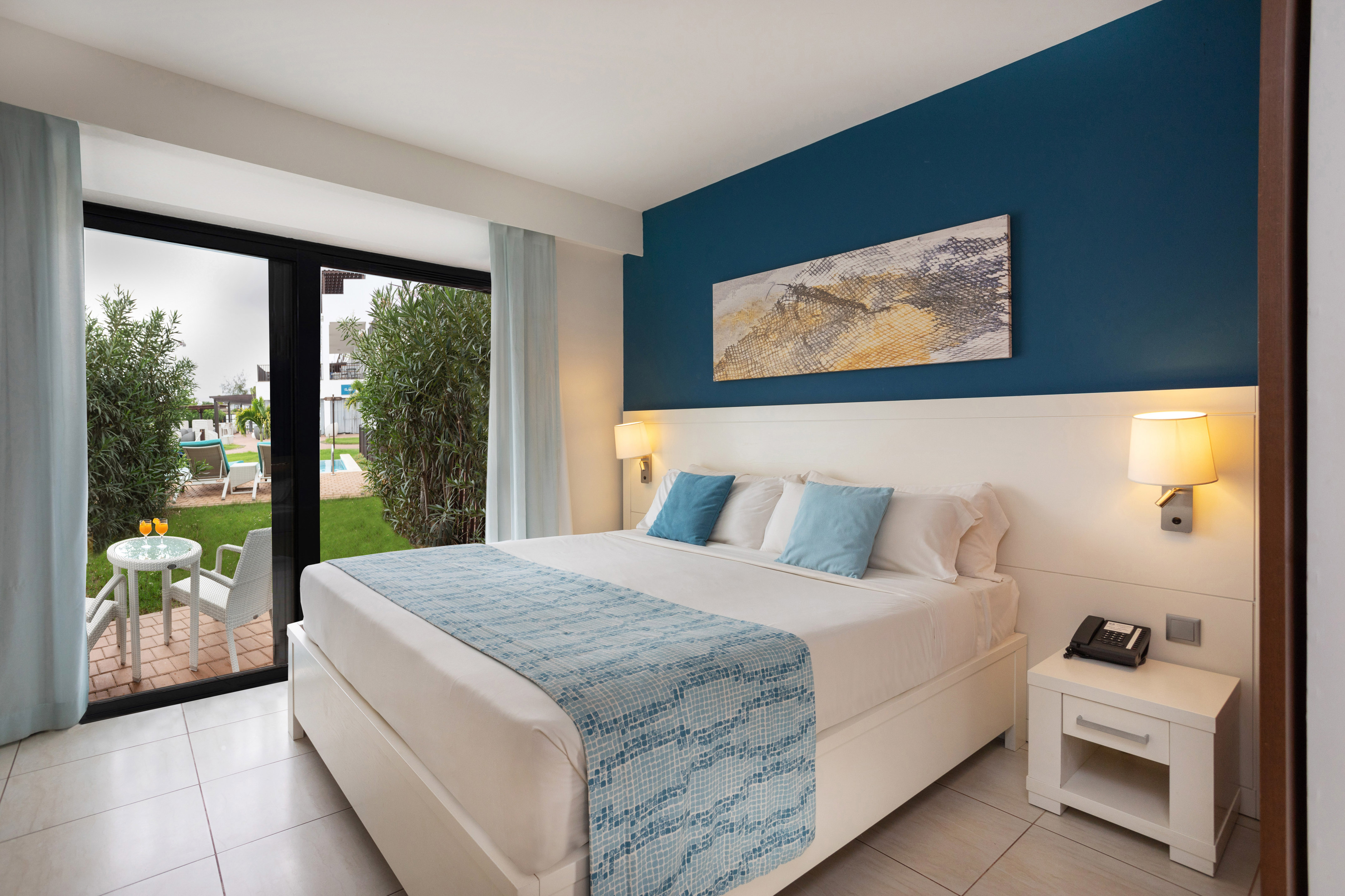 a bedroom with a bed and a glass door