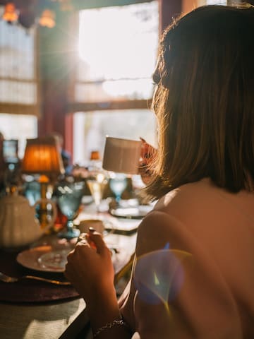 a woman holding a cup of coffee