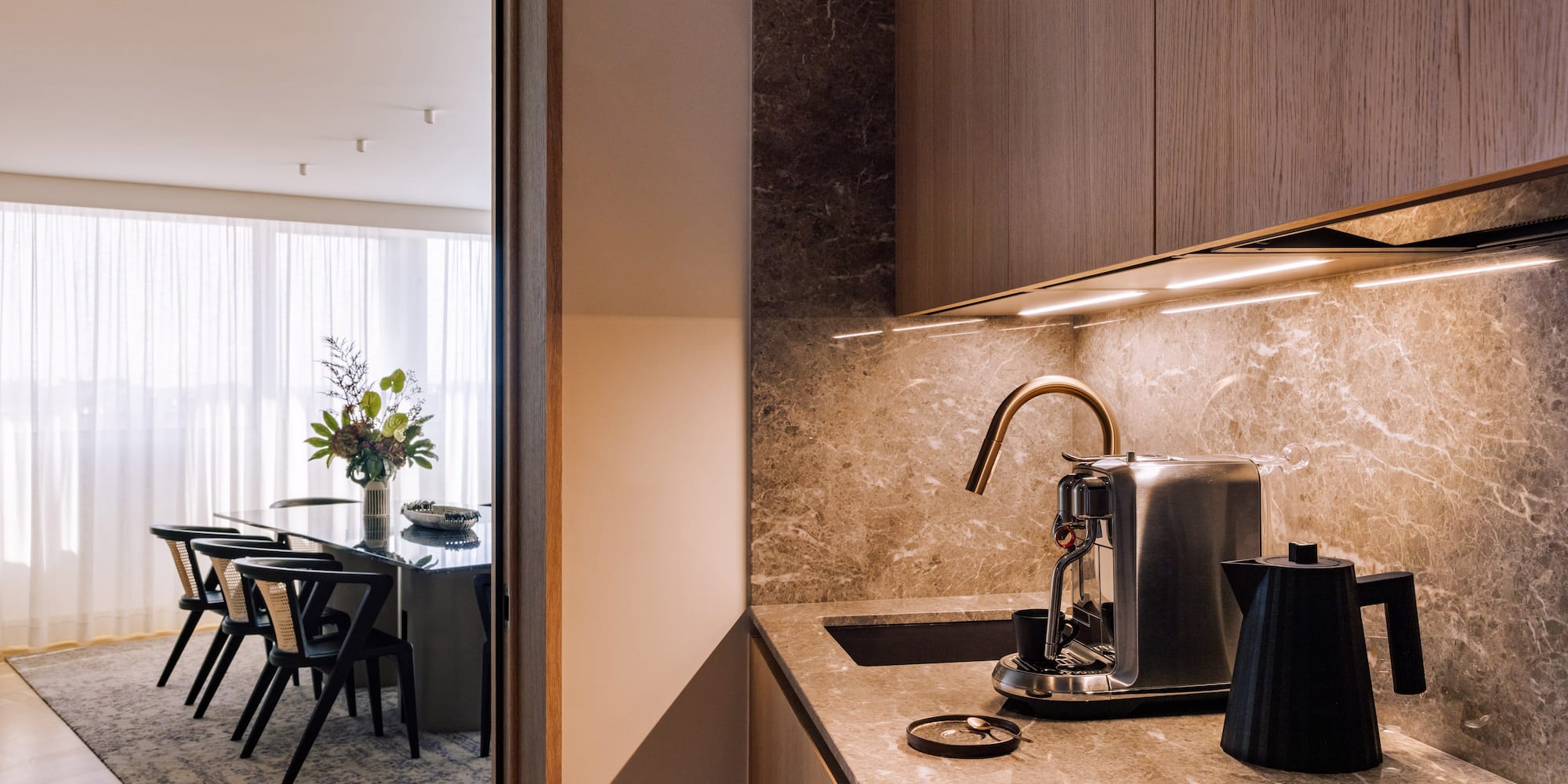 a kitchen with a coffee maker and a table