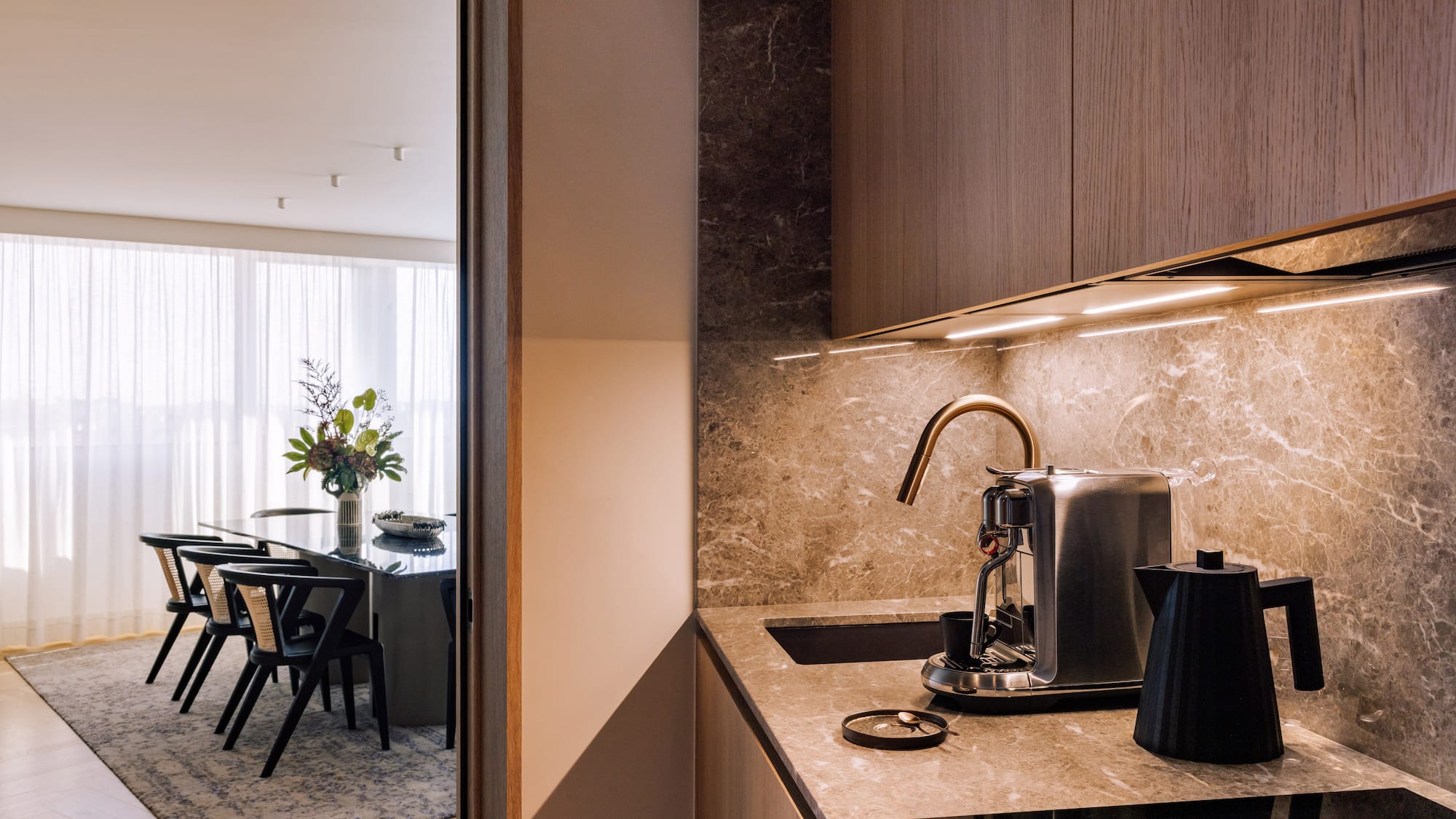 a kitchen with a coffee maker and a table