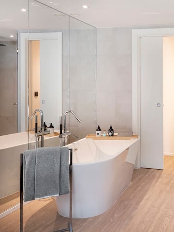 a bathroom with a bathtub and a shower