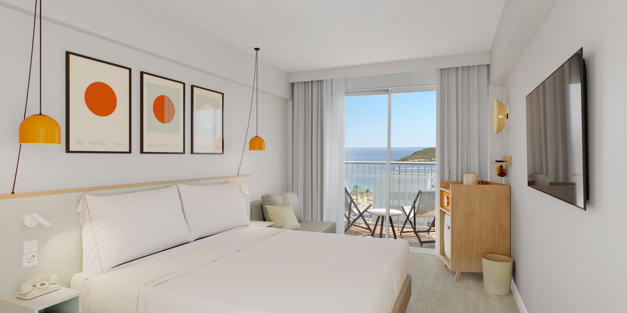 a room with a bed and a balcony overlooking the ocean