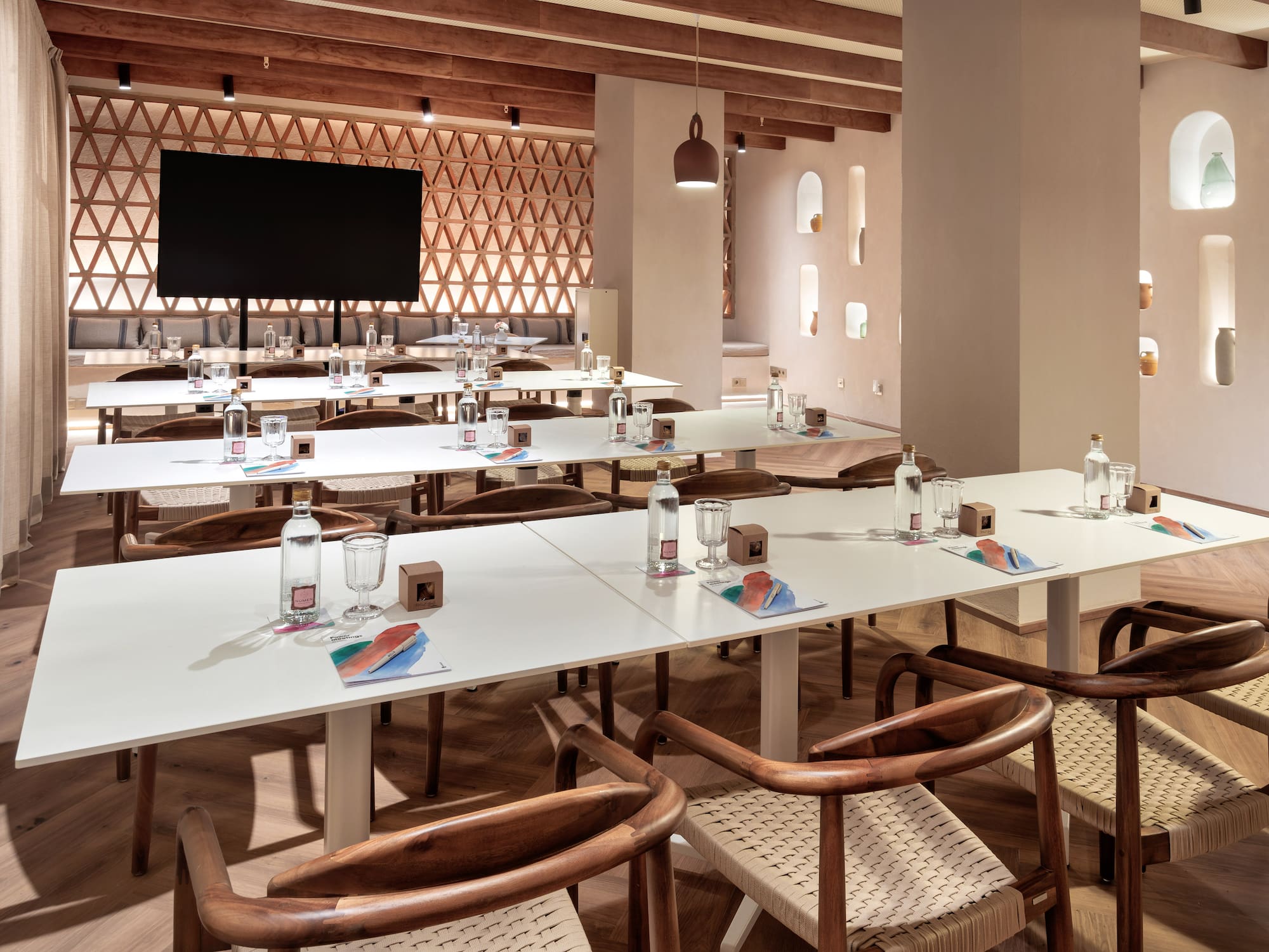 a room with white tables and chairs