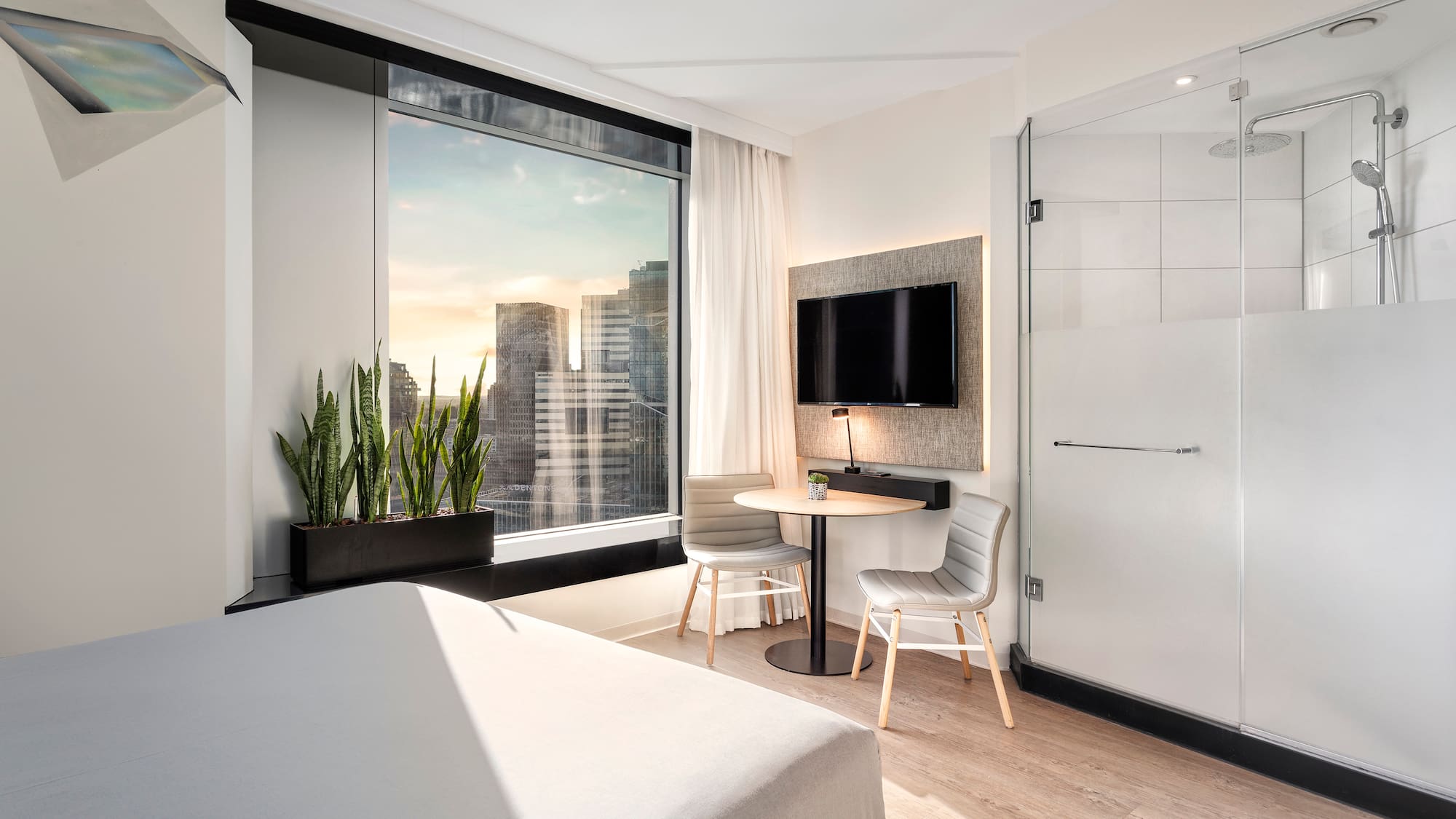 a room with a bed and a table and a tv