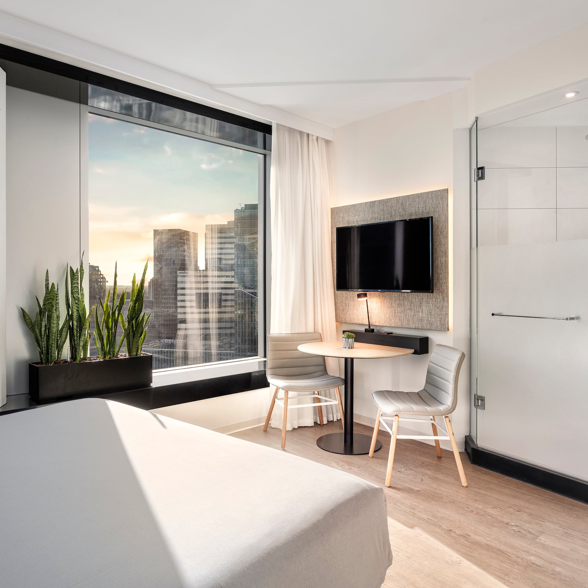 a room with a bed and a table and a tv