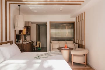 a bedroom with a bed and a table