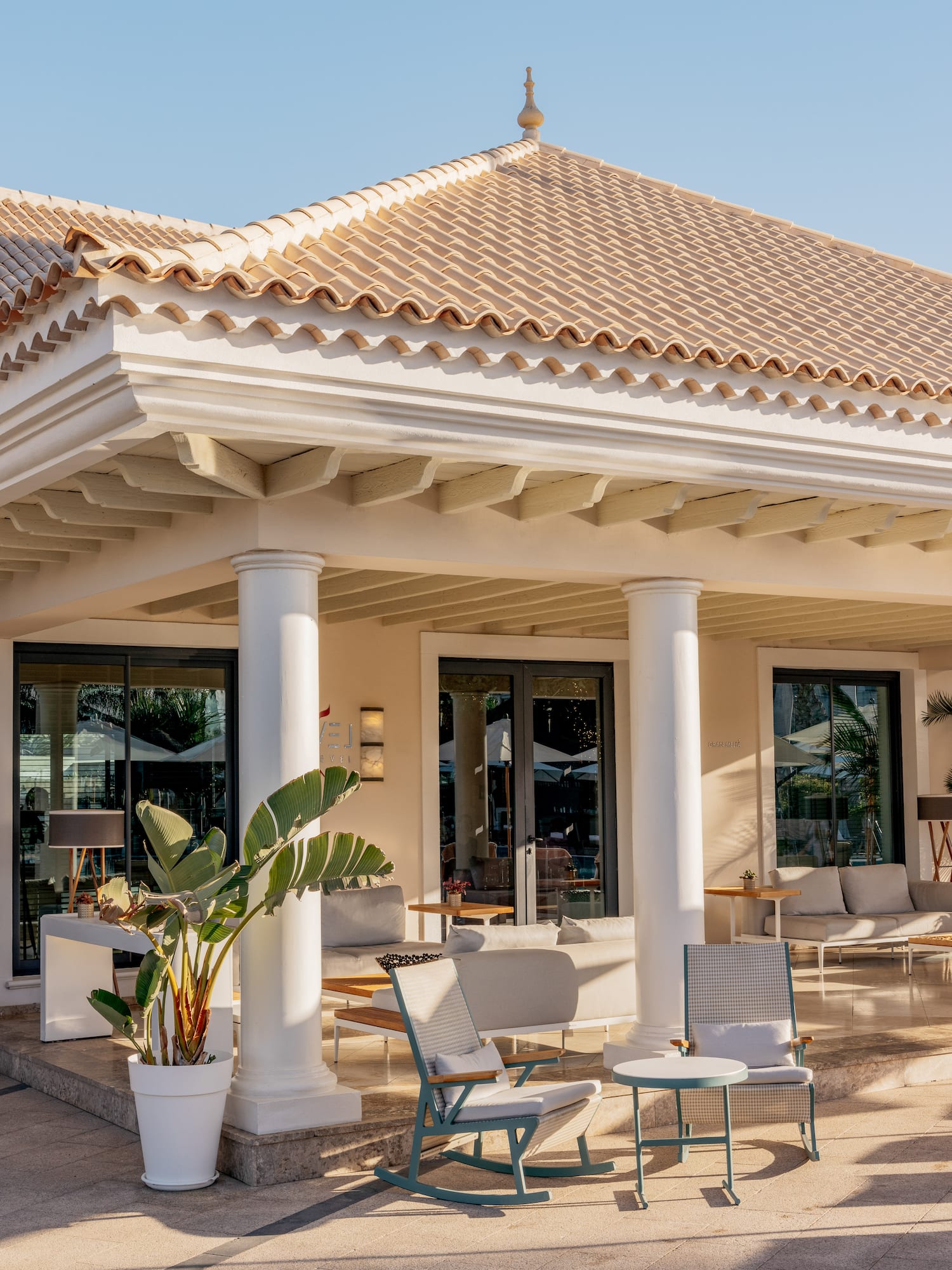 a building with columns and chairs