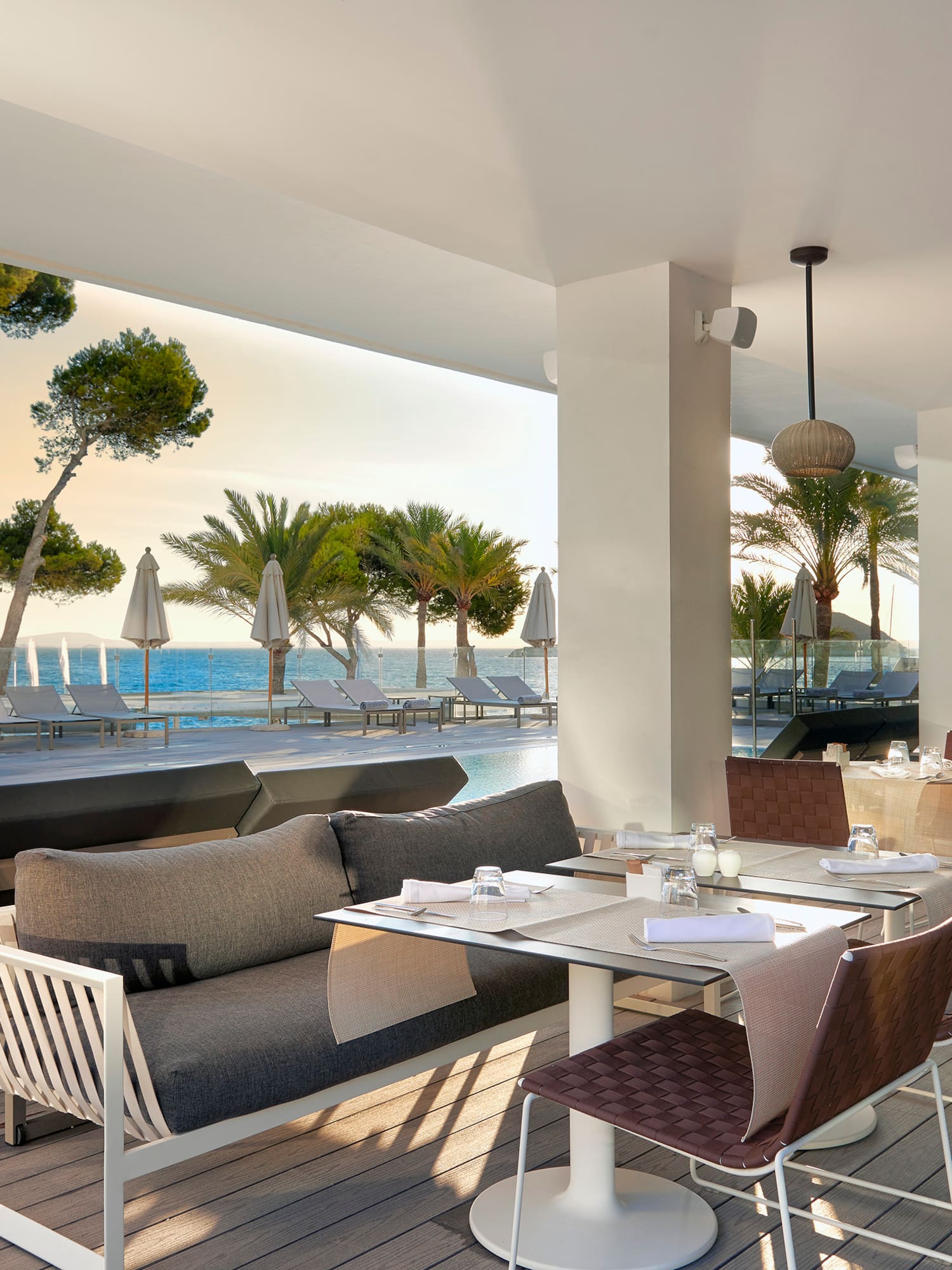 a restaurant with a pool and chairs