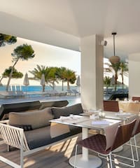 a restaurant with a pool and chairs