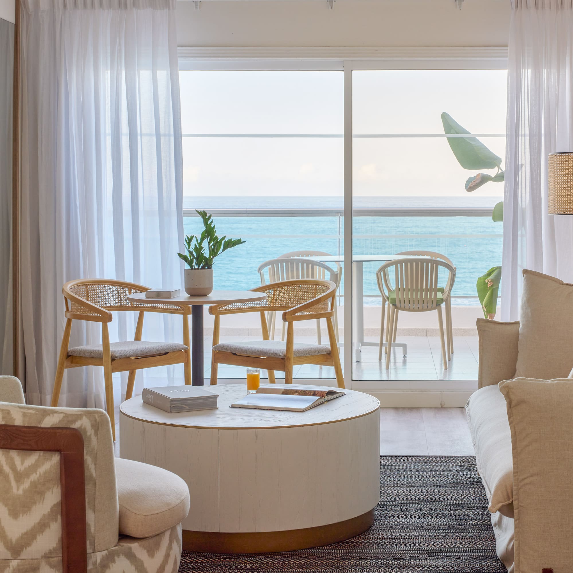 a living room with a table and chairs