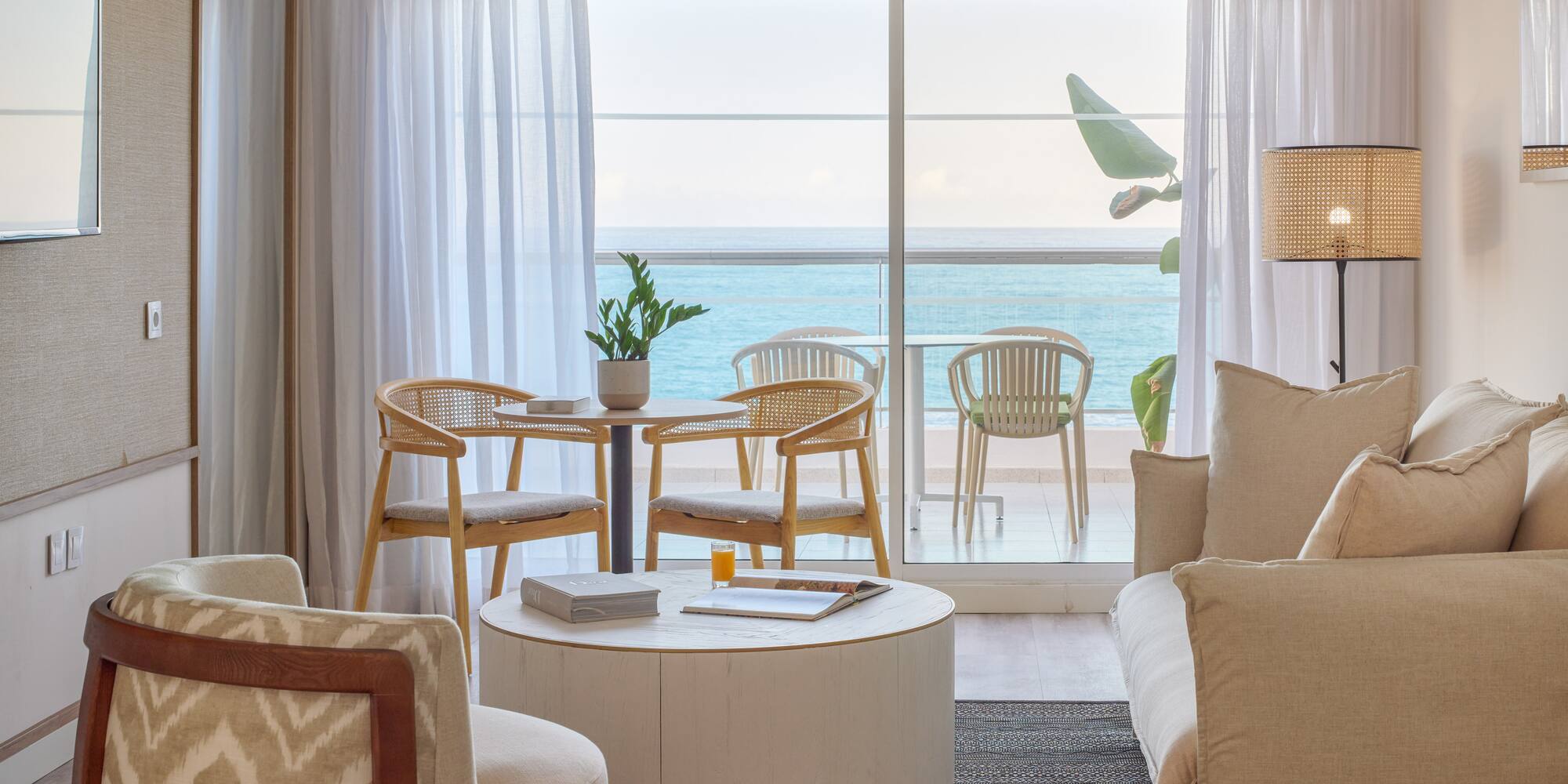 a living room with a table and chairs