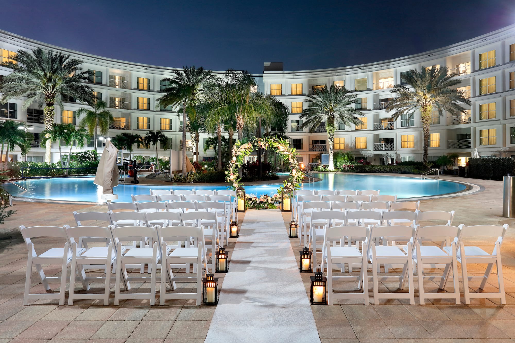 a wedding ceremony in front of a pool