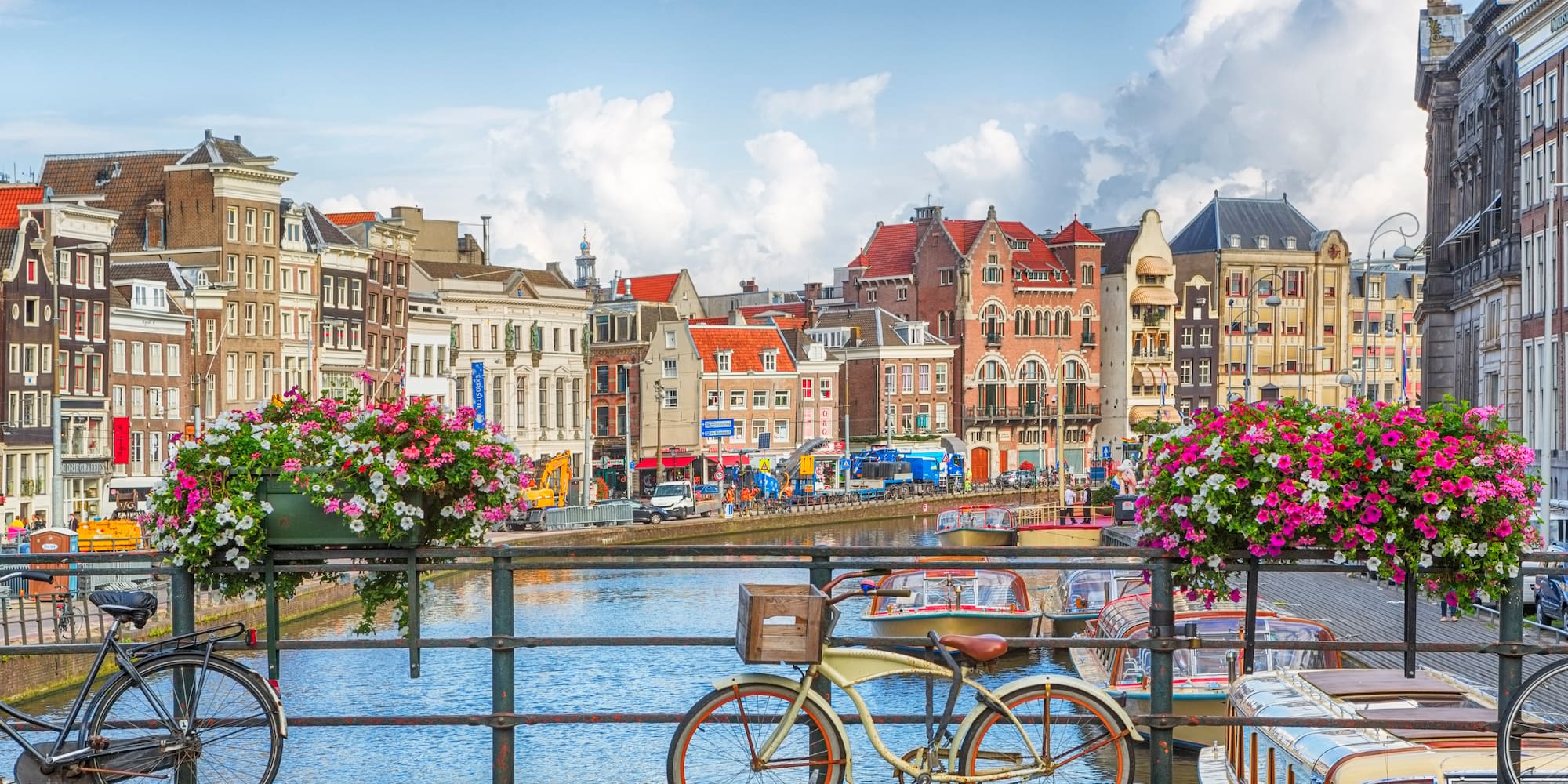 a bicycle on a bridge over a canal with flowers