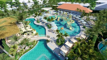 a pool with water slides and chairs and trees