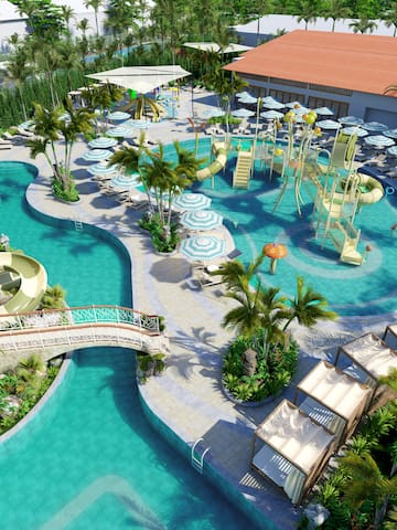 a pool with water slides and chairs and trees
