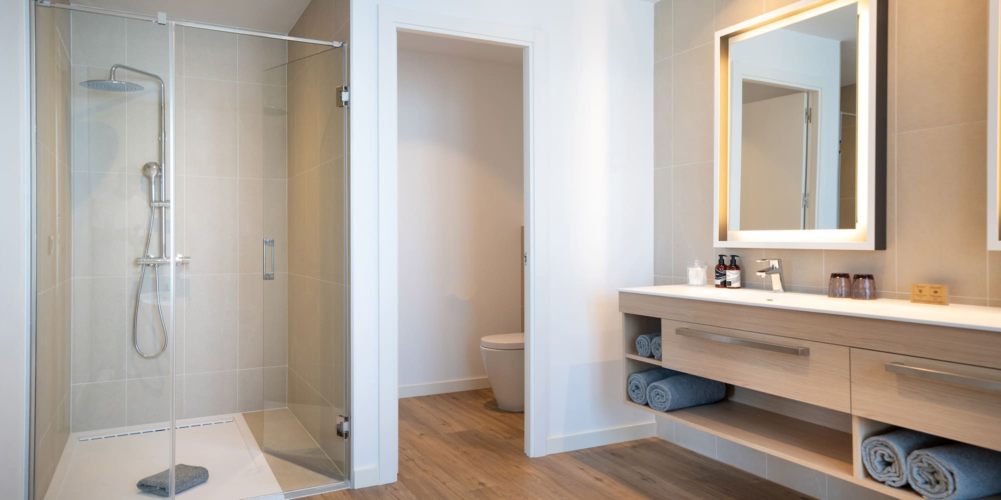 a bathroom with a glass shower and sink