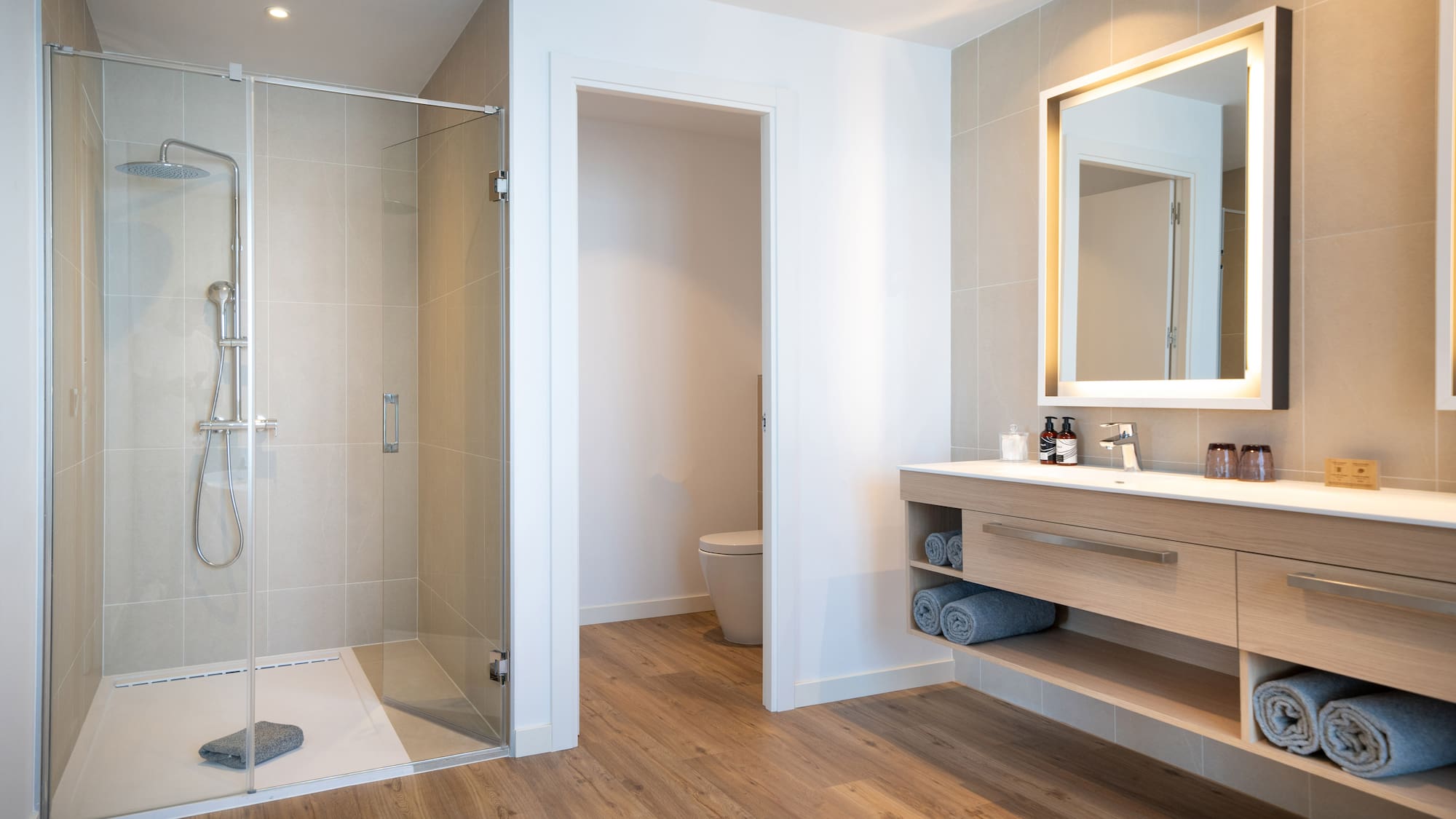 a bathroom with a glass shower and sink