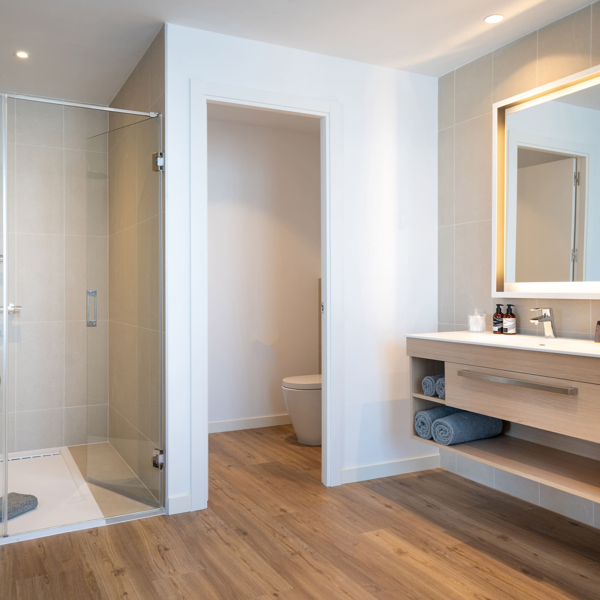 a bathroom with a glass shower and sink