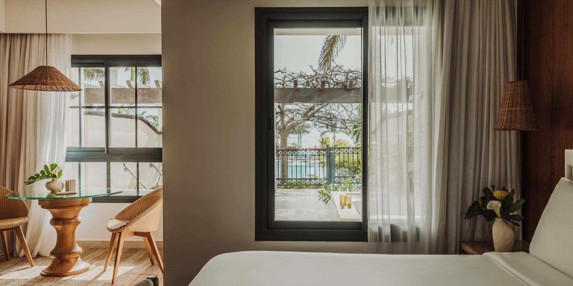 a room with a bed and a table and chairs