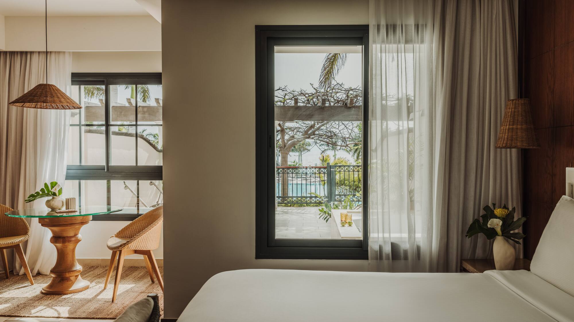 a room with a bed and a table and chairs