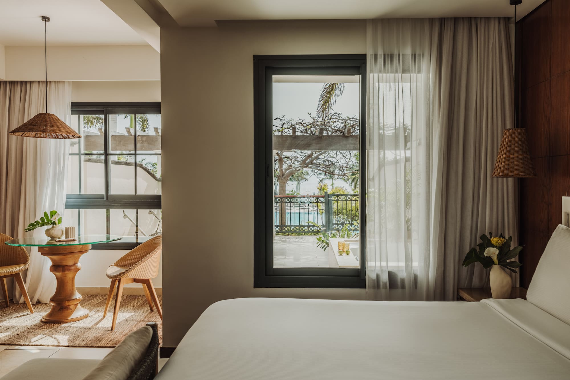 a room with a bed and a table and chairs