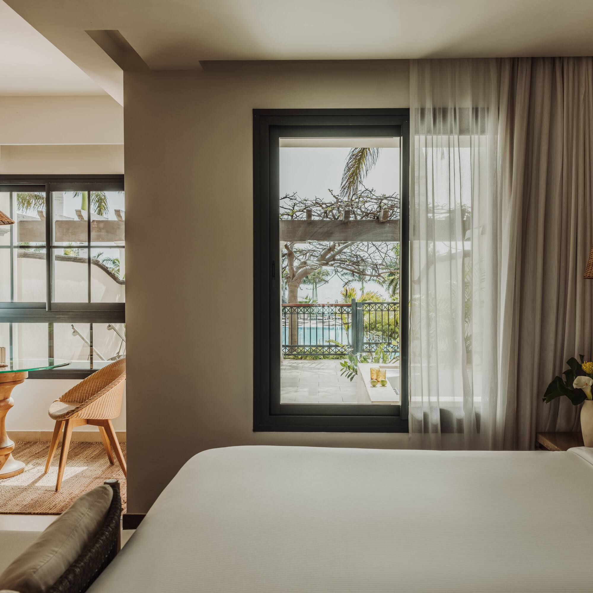 a room with a bed and a table and chairs