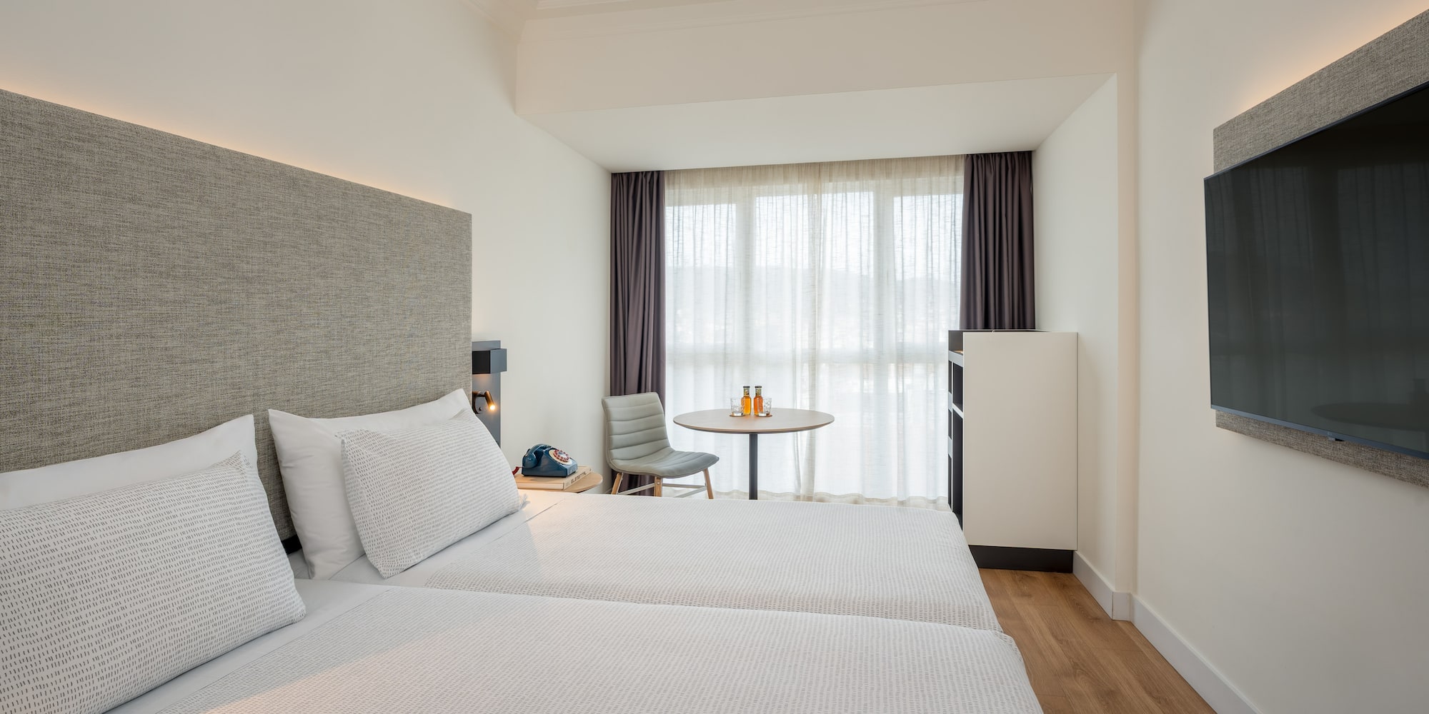 a room with two beds and a table