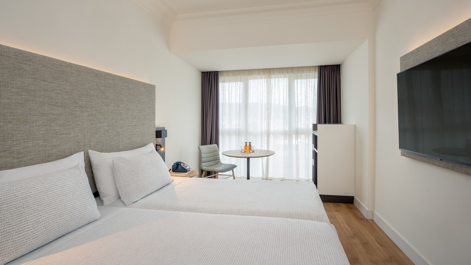 a room with two beds and a table