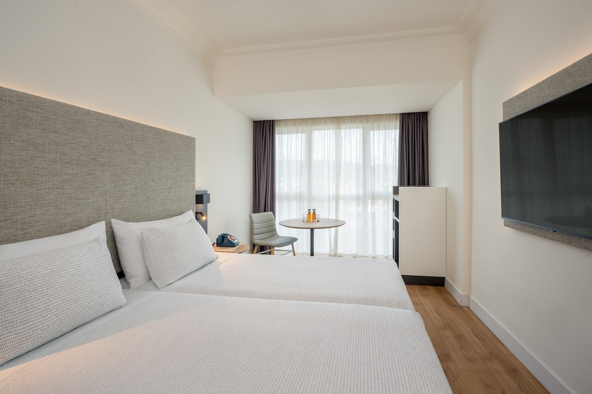 a room with two beds and a table