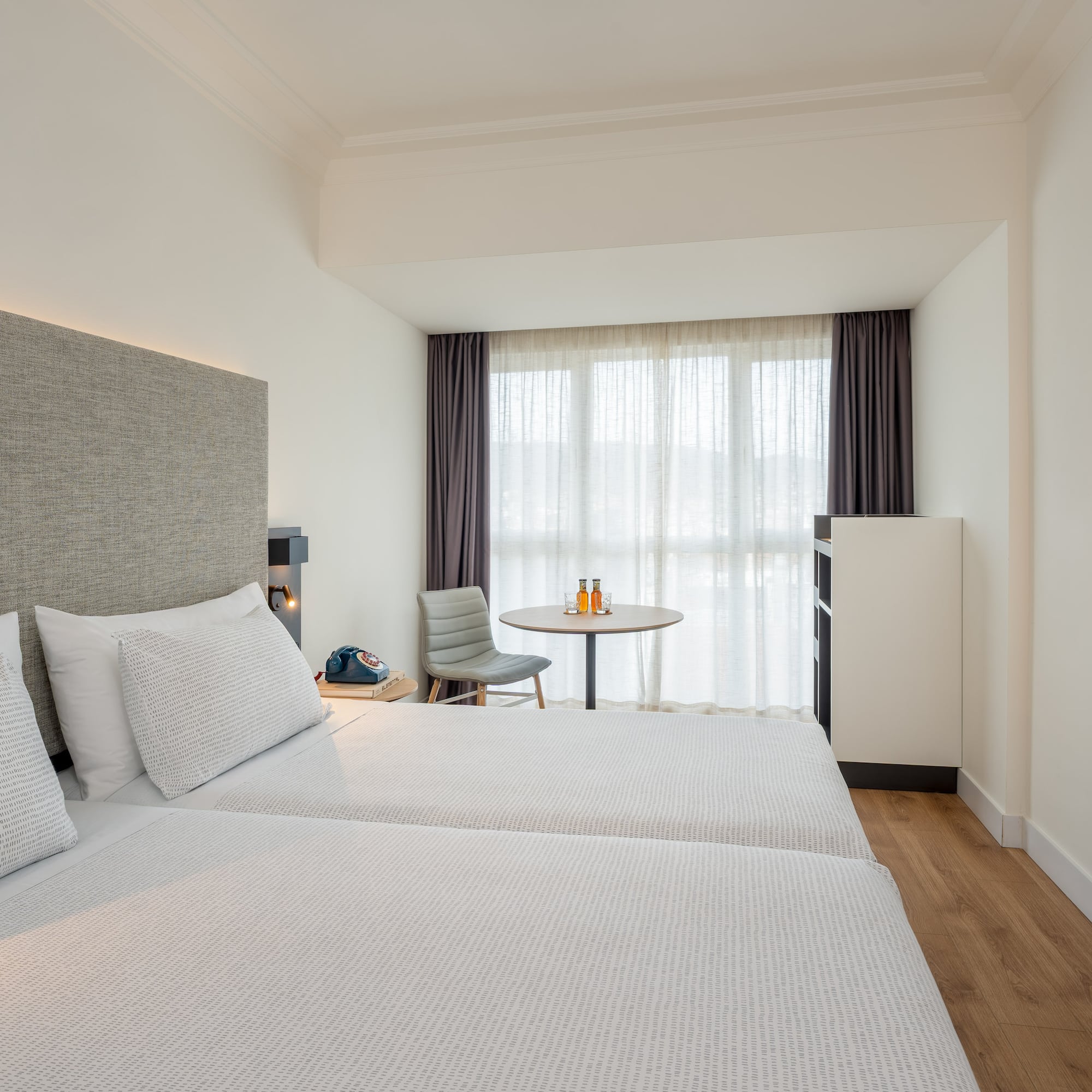 a room with two beds and a table