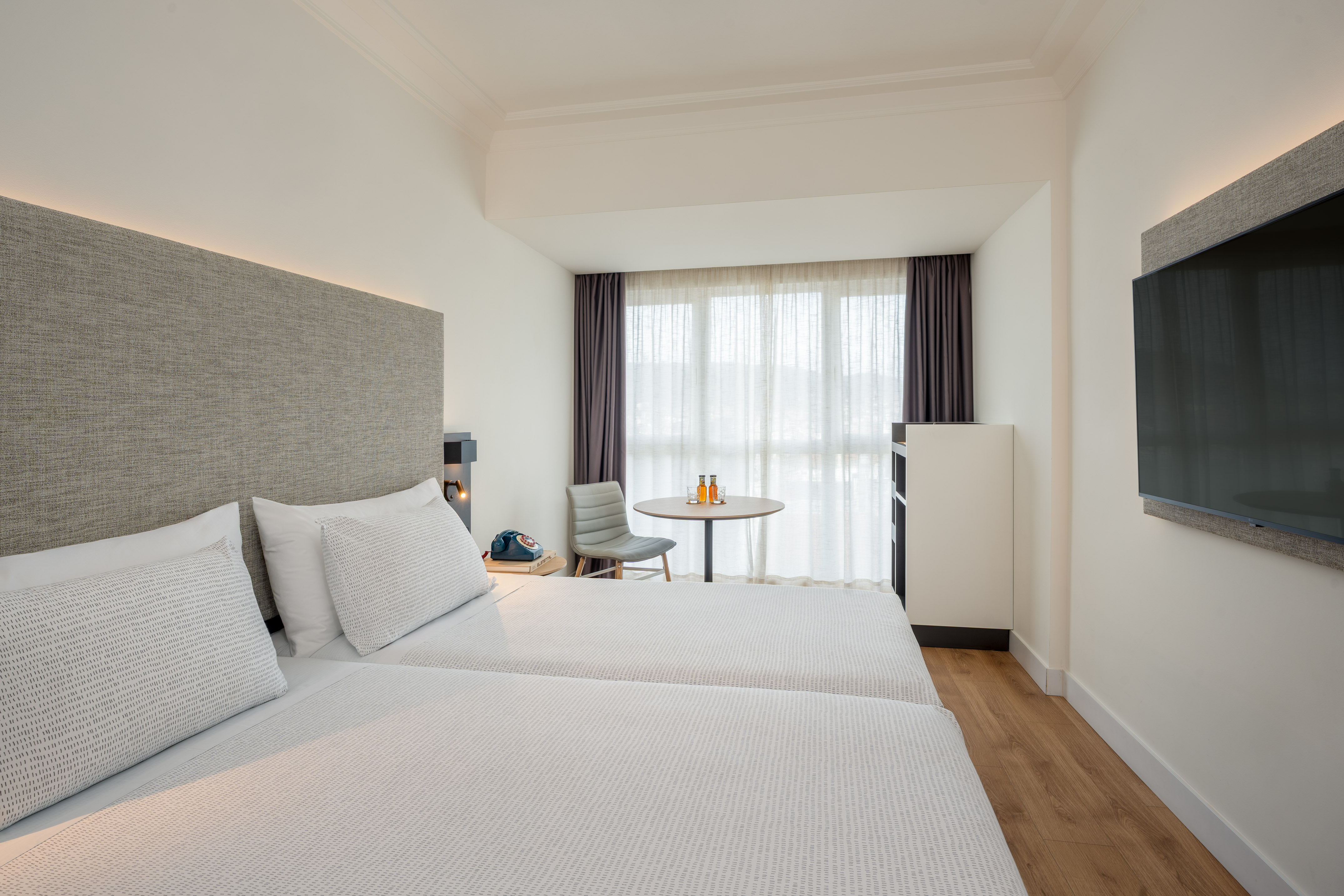 a room with two beds and a table