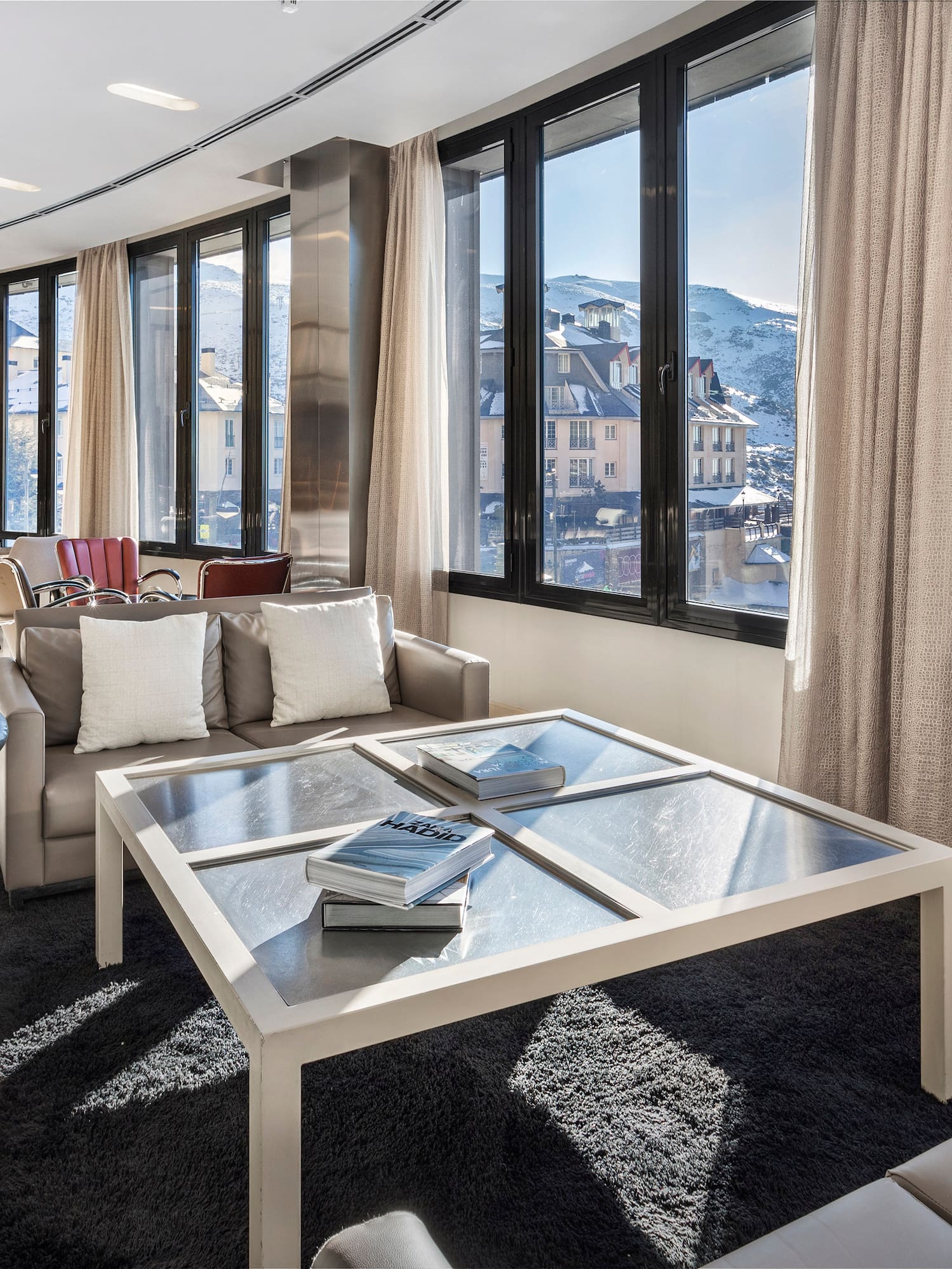 a room with a glass table and chairs
