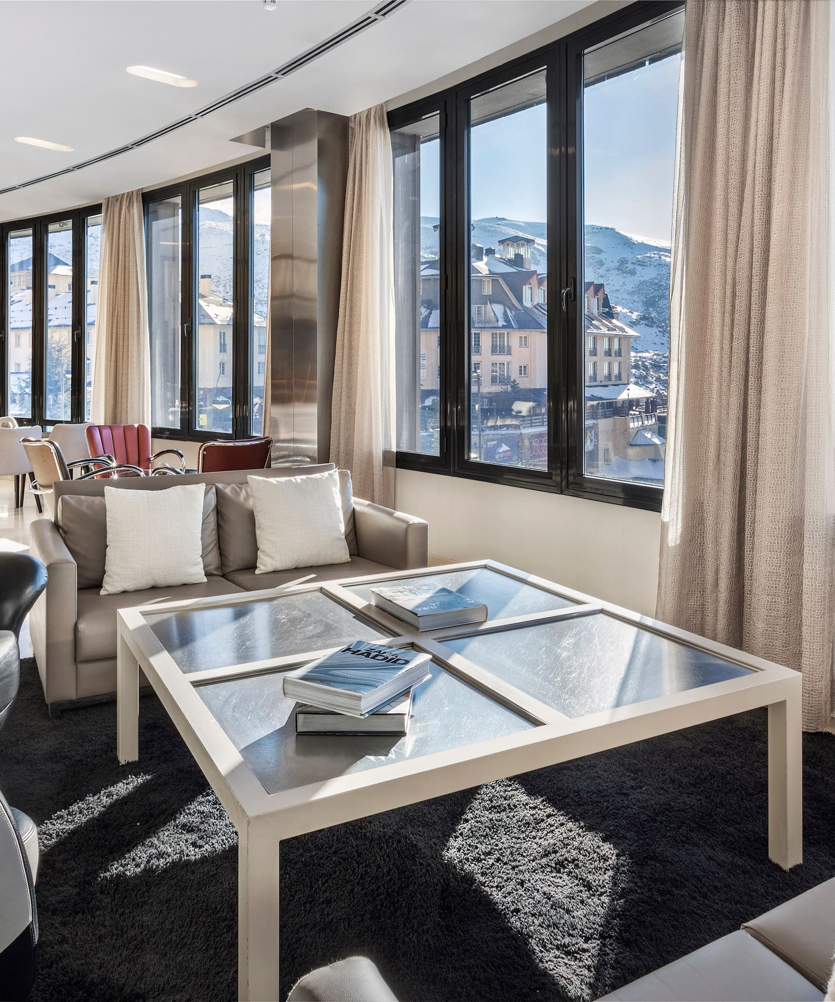 a room with a glass table and chairs