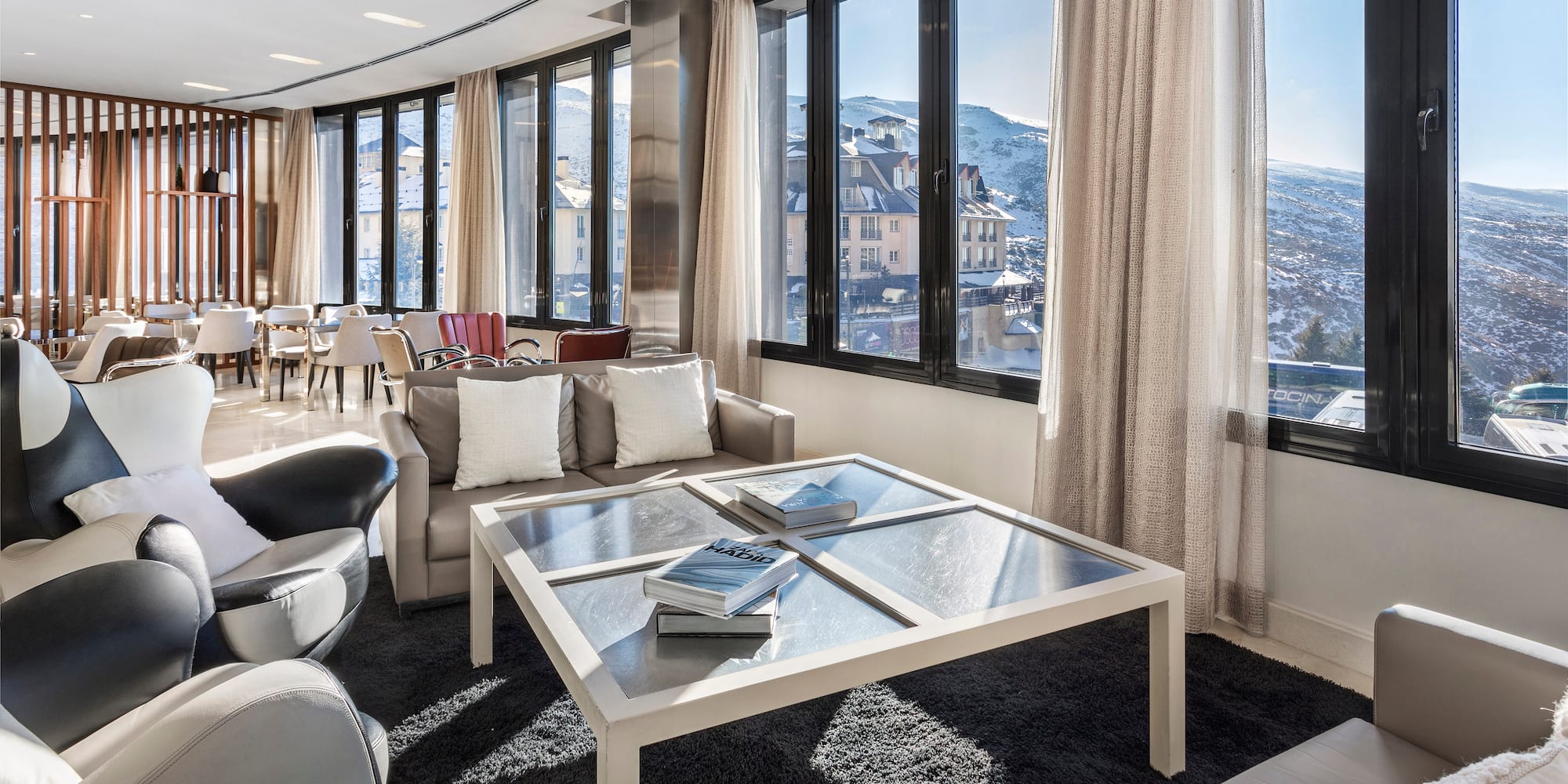 a room with a glass table and chairs