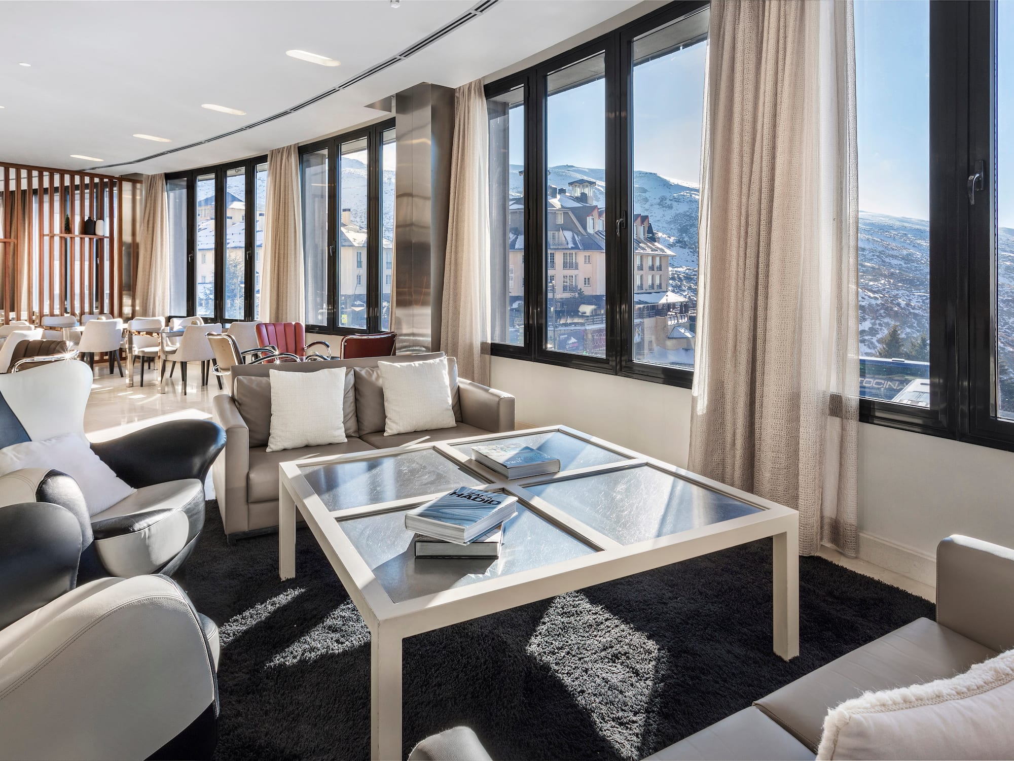a room with a glass table and chairs