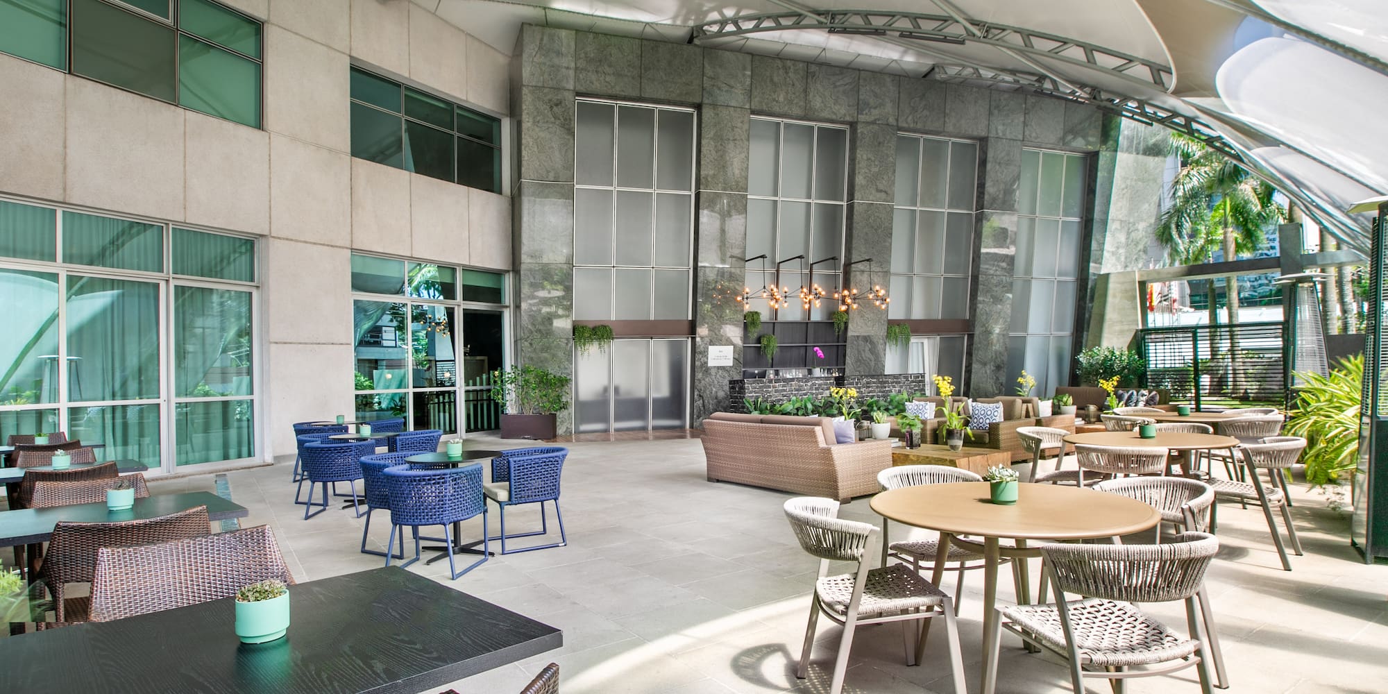 a patio with tables and chairs