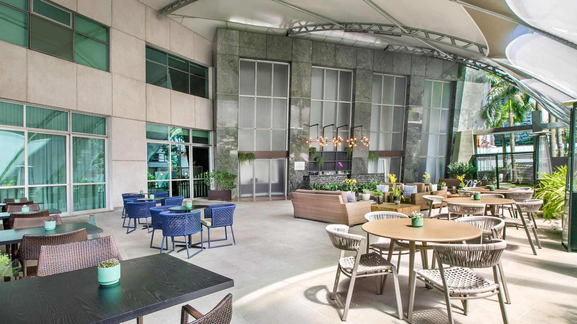 a patio with tables and chairs