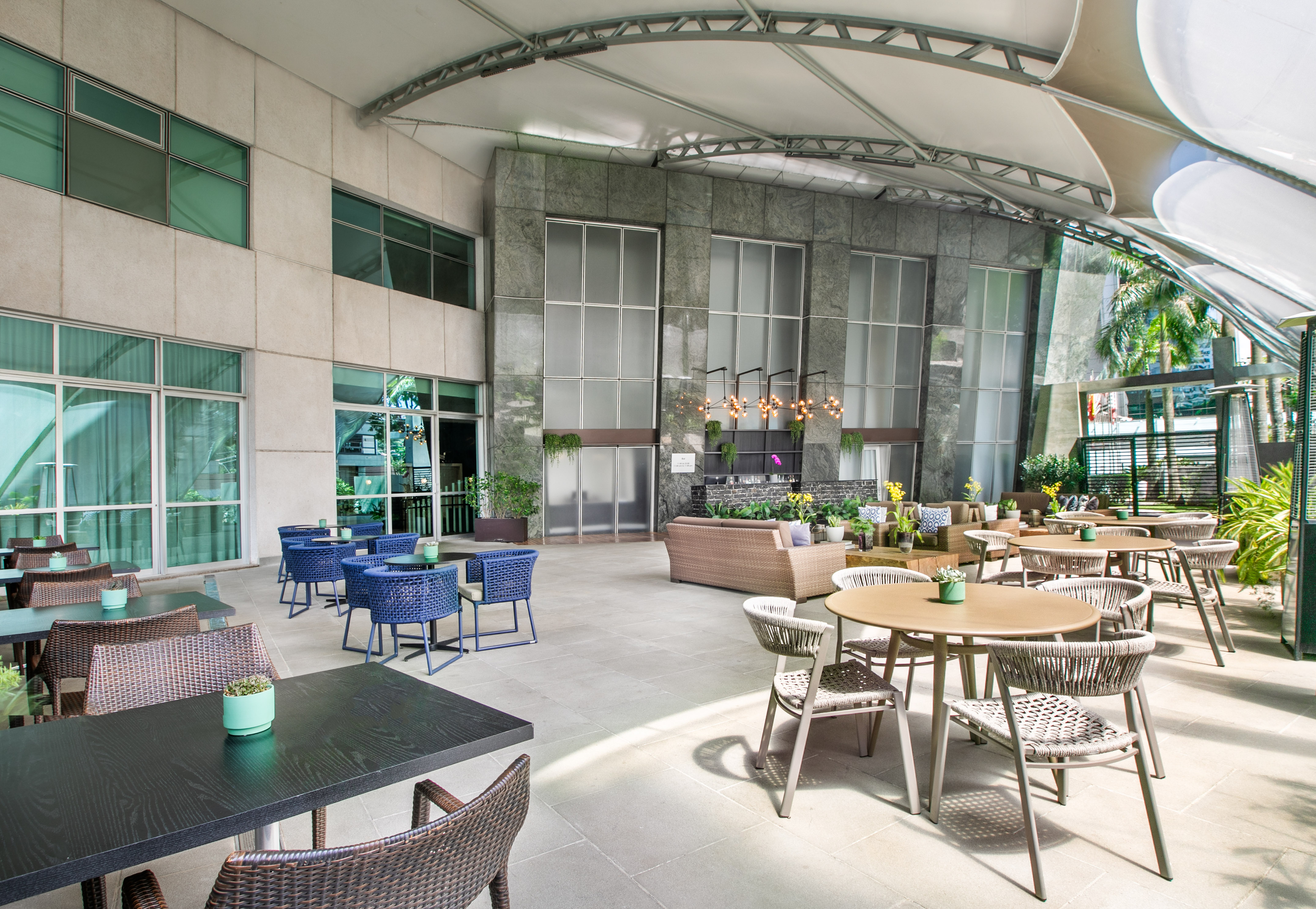 a patio with tables and chairs