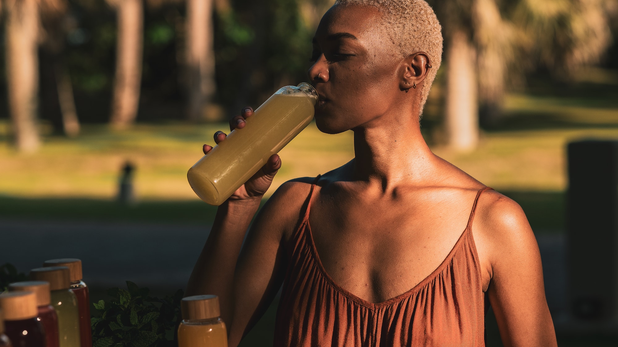 a woman drinking from a bottle