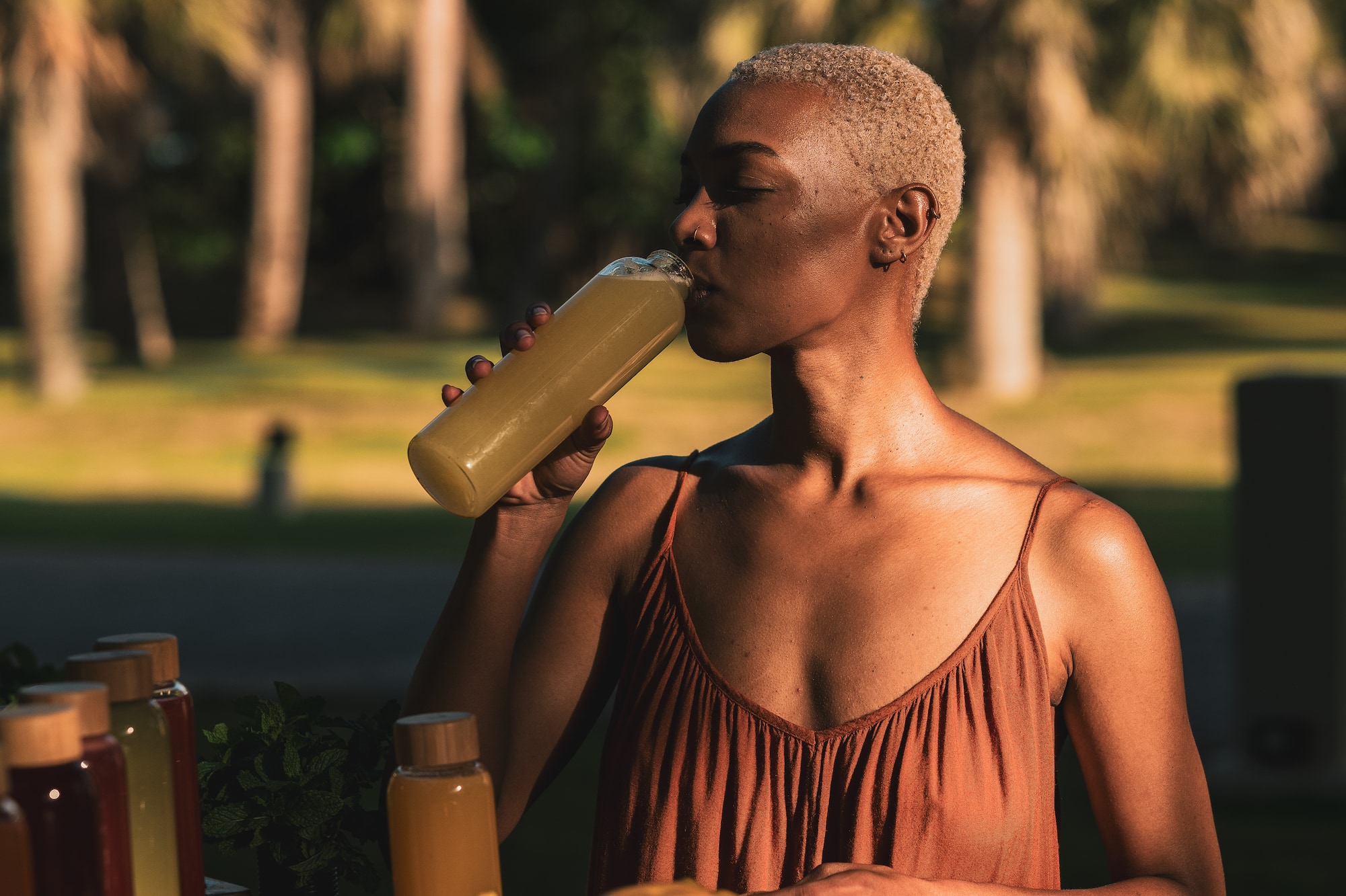 a woman drinking from a bottle