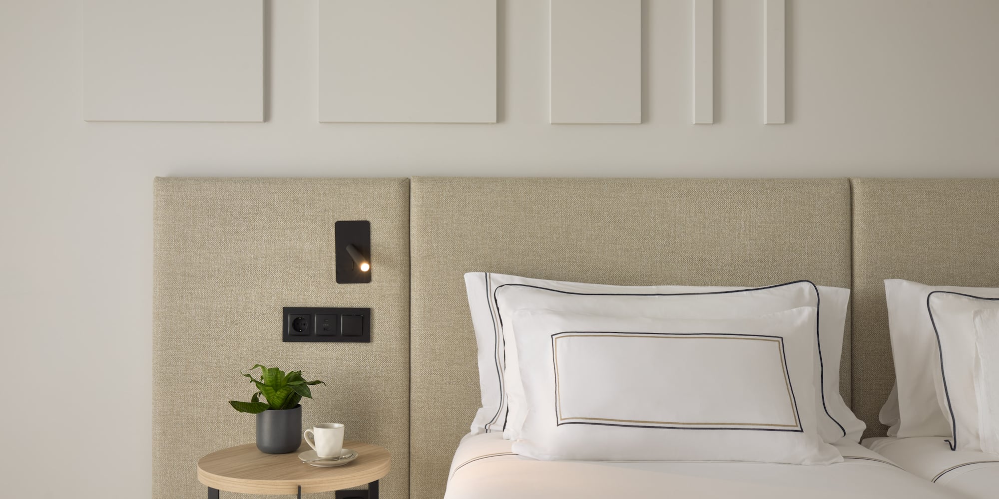 a bed with a plant on a table