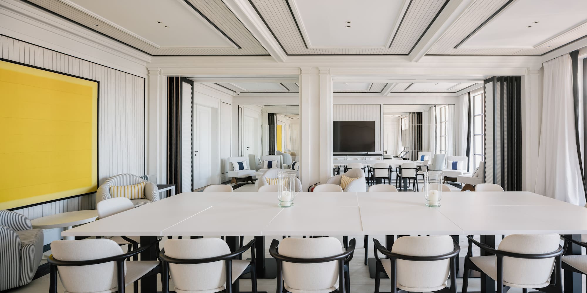 a room with white tables and chairs