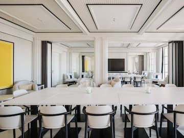 a room with white tables and chairs