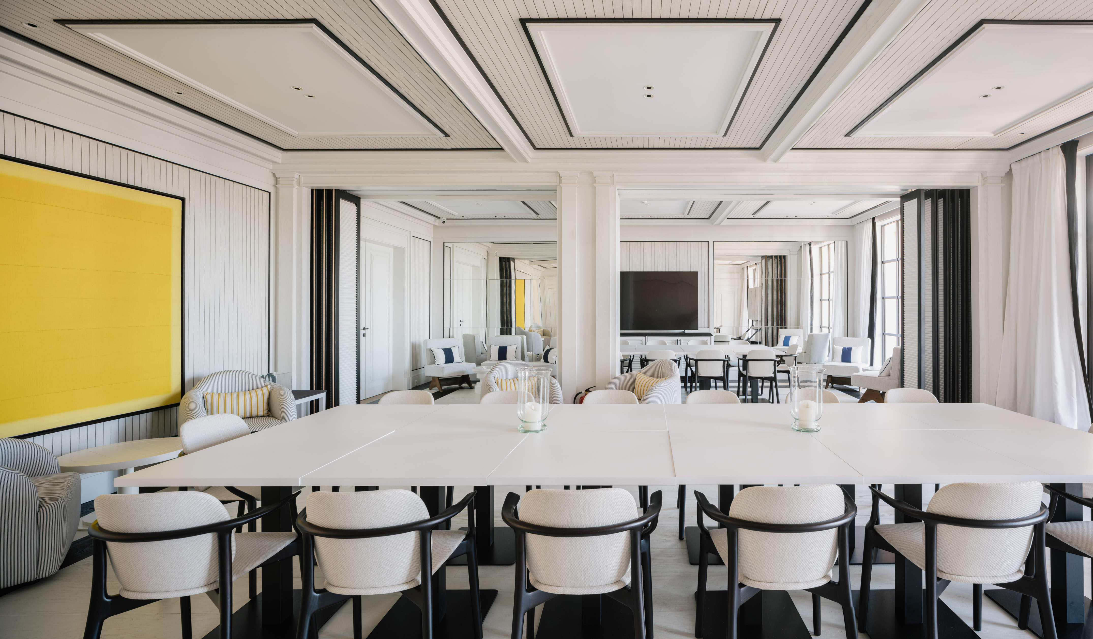 a room with white tables and chairs