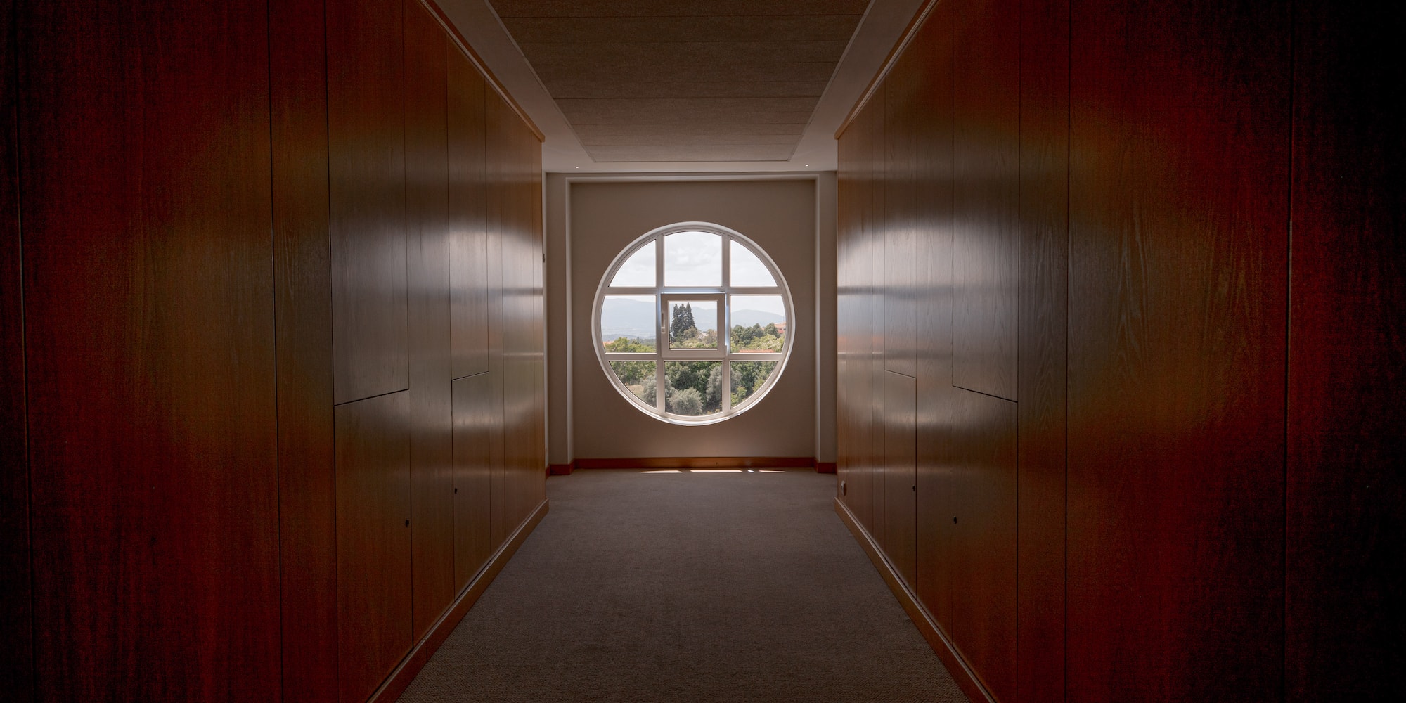 a hallway with a round window